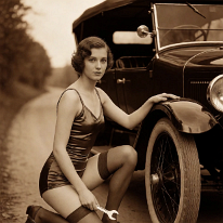 Clever Girls Know How to Fix Things Young woman kneels beside the front wheel of a vintage touring car, one hand on the fender, the other holding an adjustable wrench, looking at the camera. She...